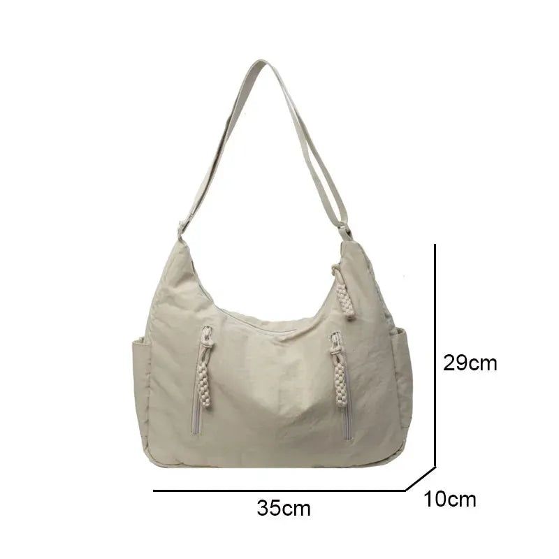 Trendy beige soft-cloth shoulder bag by Simples Market; crossbody with front zip pockets and tassel pulls, 35x29x10 cm