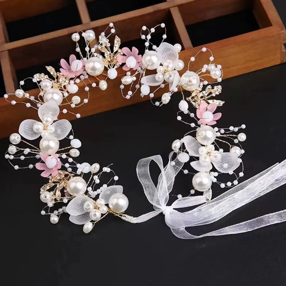 Pearl hair crown for girls with pink floral accents and white ribbon