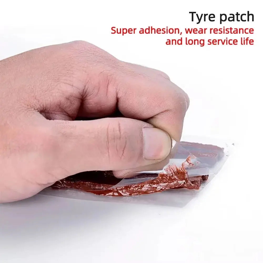 Tyre repair patch being peeled from foil backing; hand holding brown adhesive patch