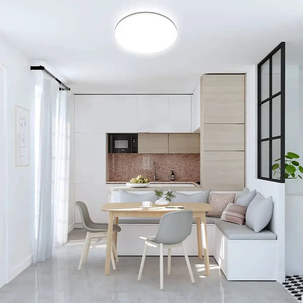 IRALAN LED ultra-thin ceiling light by Simples Market, round white fixture over a modern white kitchen and dining area.