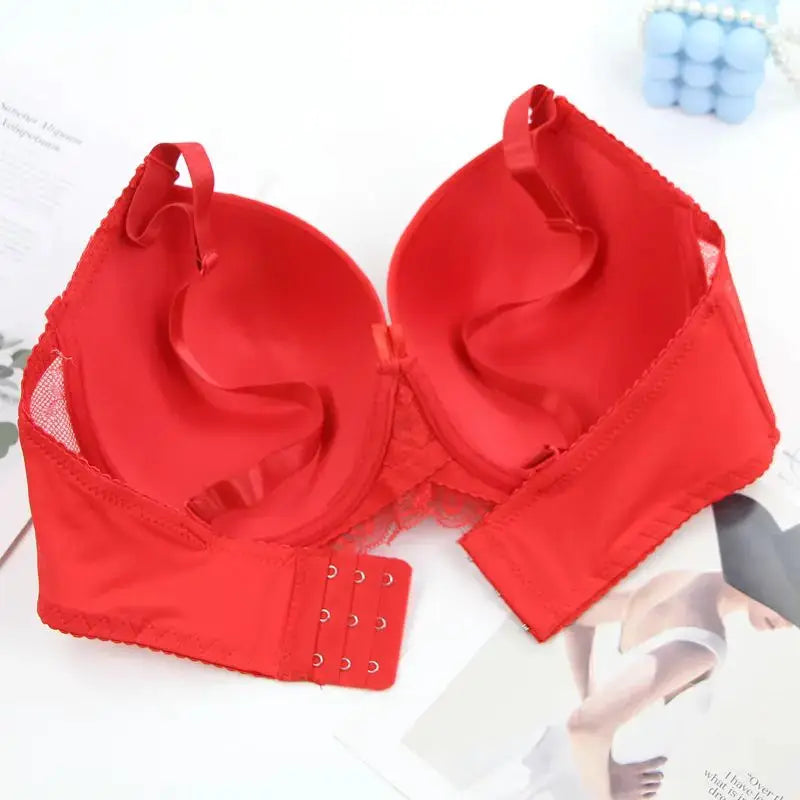 Red push-up bra with bow accents, lace trim, and adjustable straps.