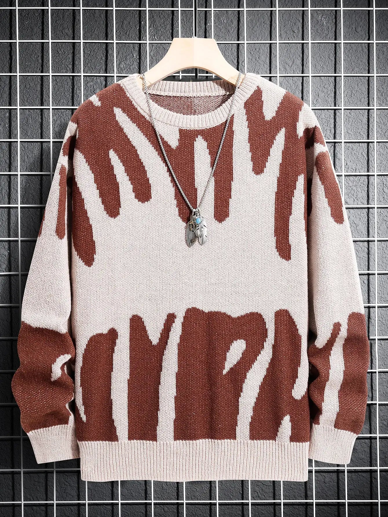 Men's pink knit pullover sweater with jacquard pattern and round neck.