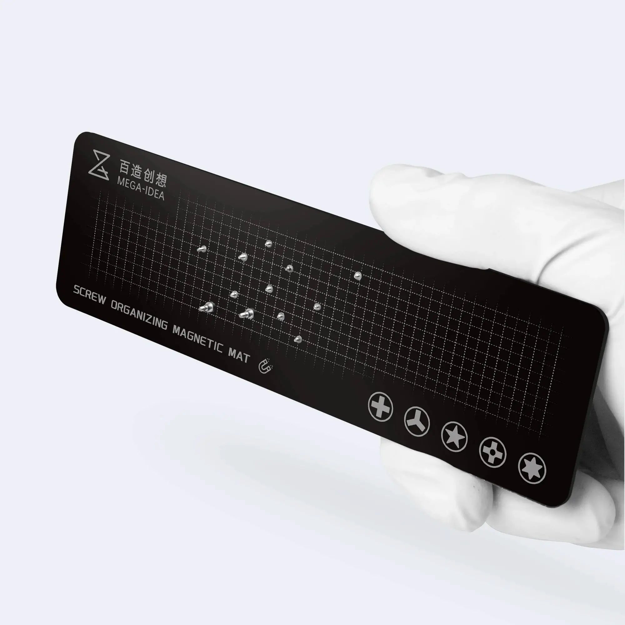 Qianli MEGA-IDEA screw organizing magnetic mat, black grid surface with exposed screws, held by a gloved hand