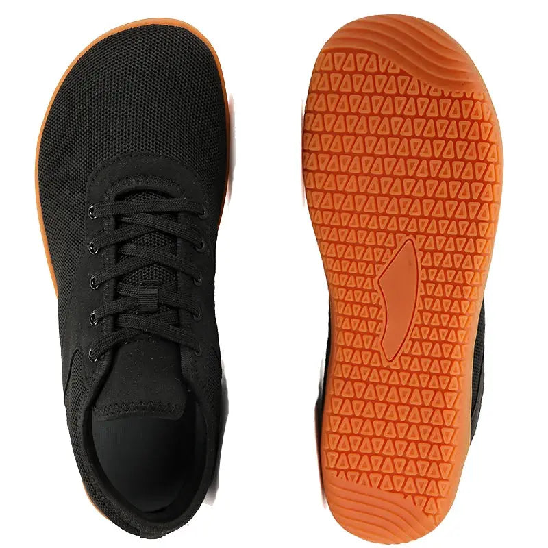 Trail running shoes, black mesh uppers with orange outsole, pair