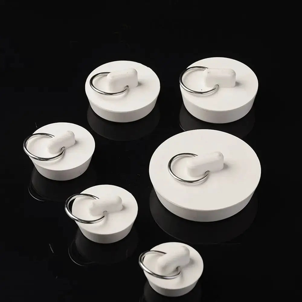 White rubber sink plugs with metal rings by Simples Market, assorted sizes