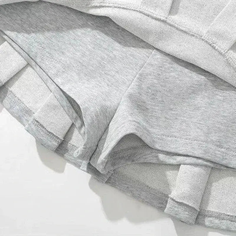 Simples Market gray hoodie fabric close-up with heather knit and ribbed cuffs.