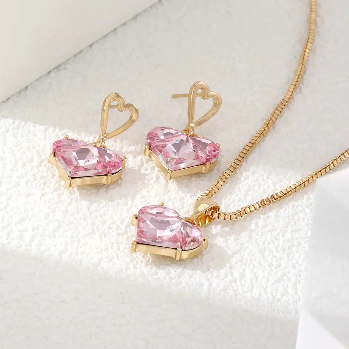 Peach heart necklace and matching earrings set in gold-tone zinc alloy with pink crystals; Simples Market
