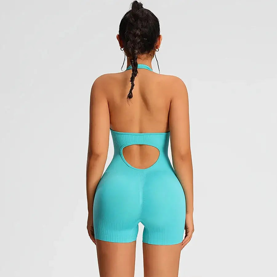 Turquoise women's halter-back romper jumpsuit with circular back cutout and ribbed fabric