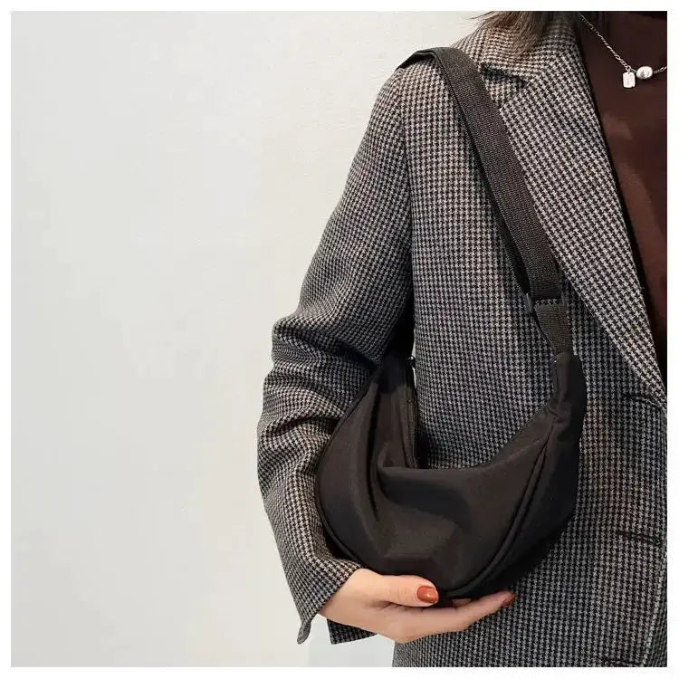 Nylon dumpling bag by Simples Market, black lightweight crossbody bag with a wide adjustable strap.