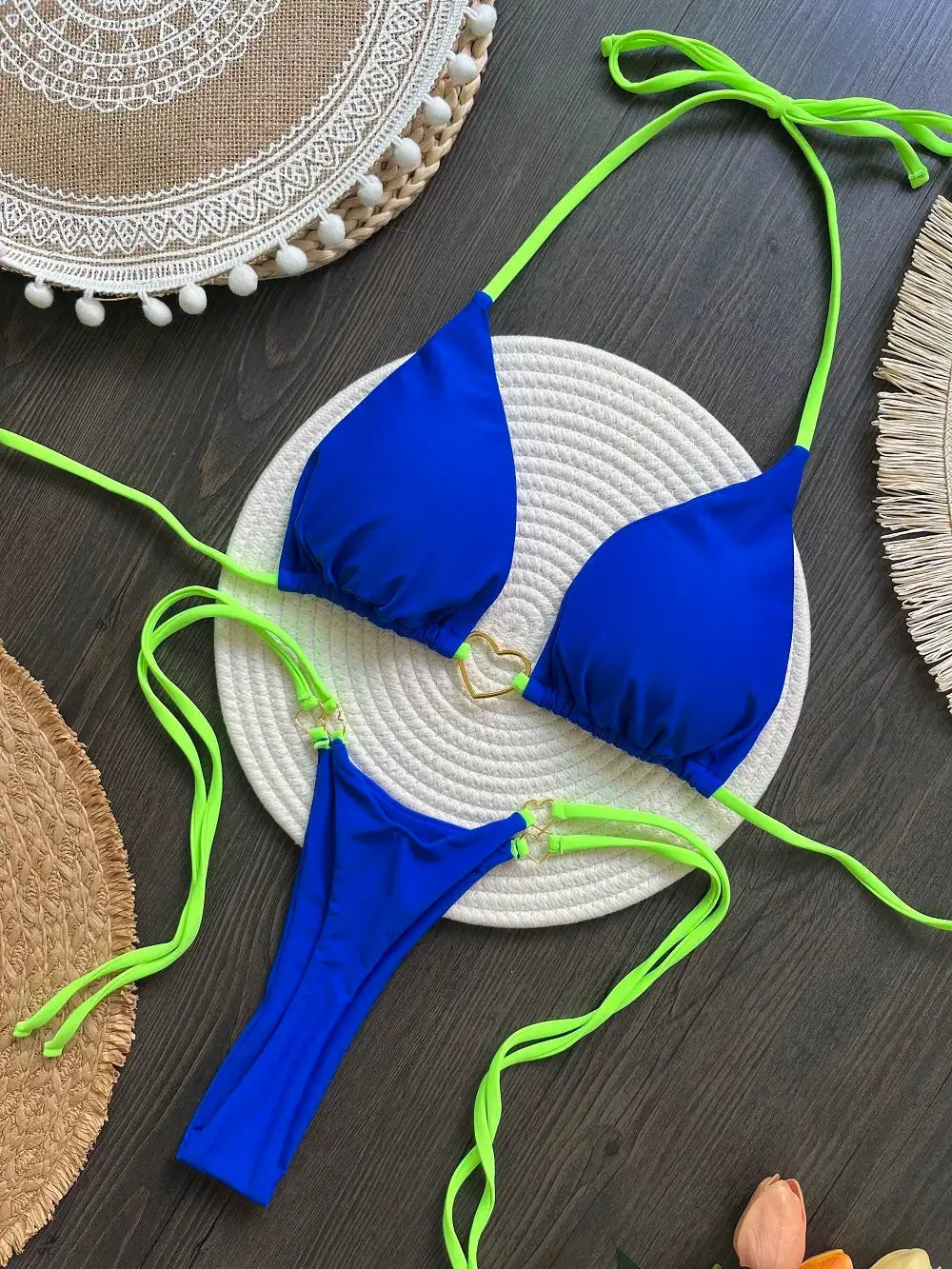 Blue two-piece bikini set with neon lime-green strings; triangle halter top and thong-style bottoms.