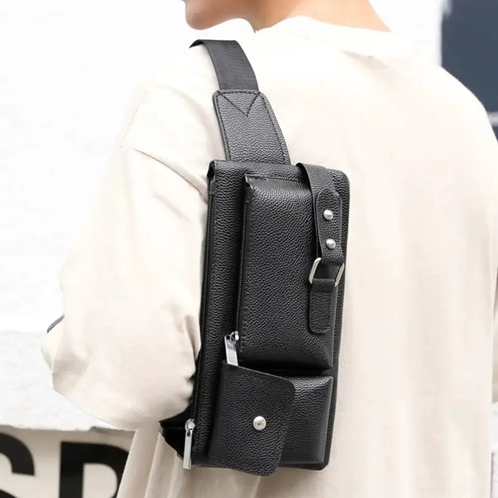 Black leather waist bag with multiple zip pockets, worn as a casual fanny pack