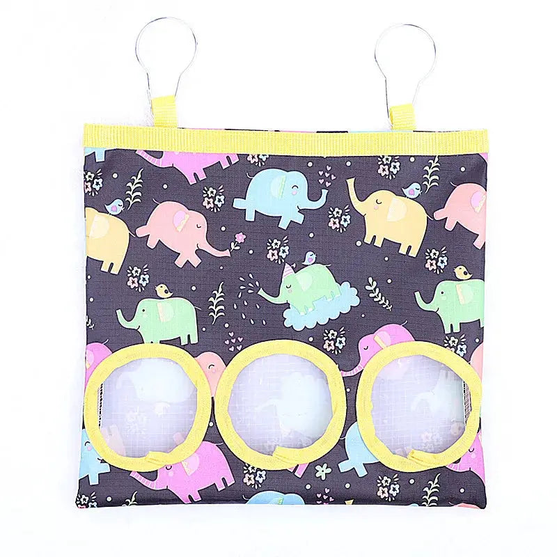 Simples Market rabbit hay bag with 3 yellow-ringed holes, elephant-print fabric, hanging hooks
