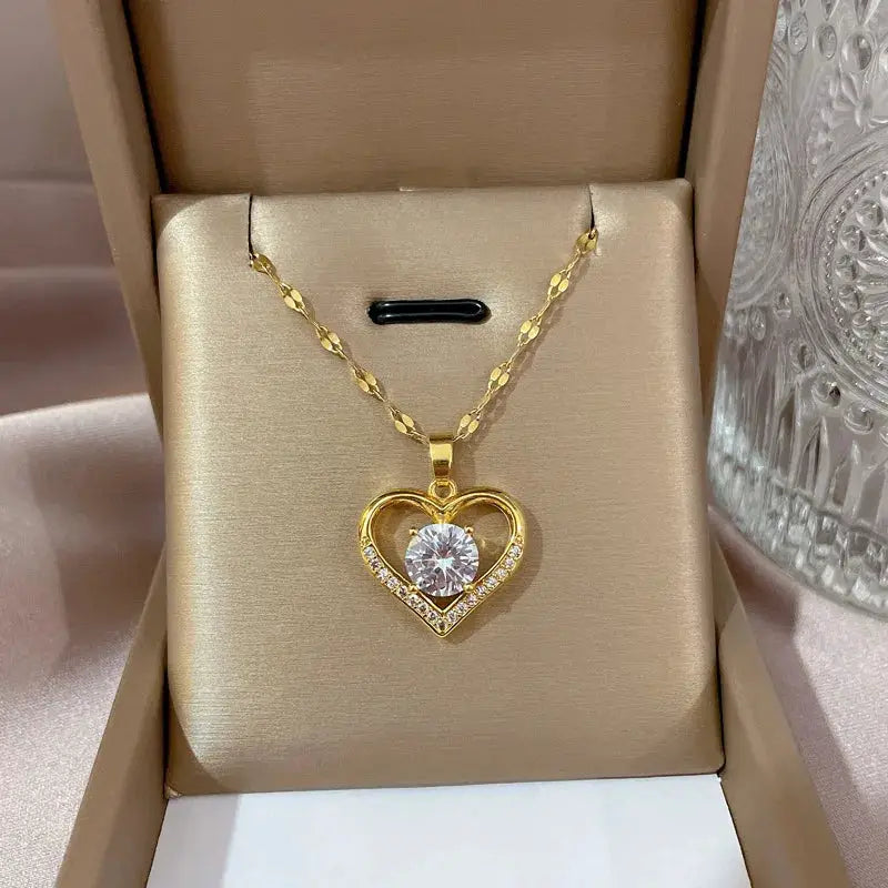 Gold heart pendant necklace with a clear center gem on a stainless steel chain by Simples Market