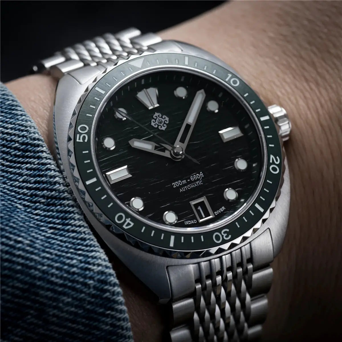 IXDAO IPOSE 2026 men's automatic diving watch on stainless steel bracelet with green bezel and Poseidon pattern dial