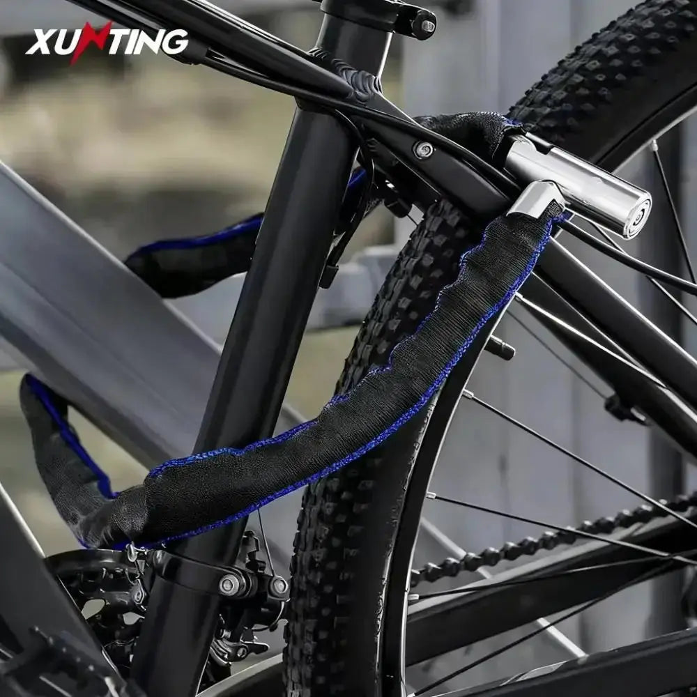 XUNTING heavy-duty bike chain lock with black nylon sleeve and 360° rotating lock on a mountain bike.