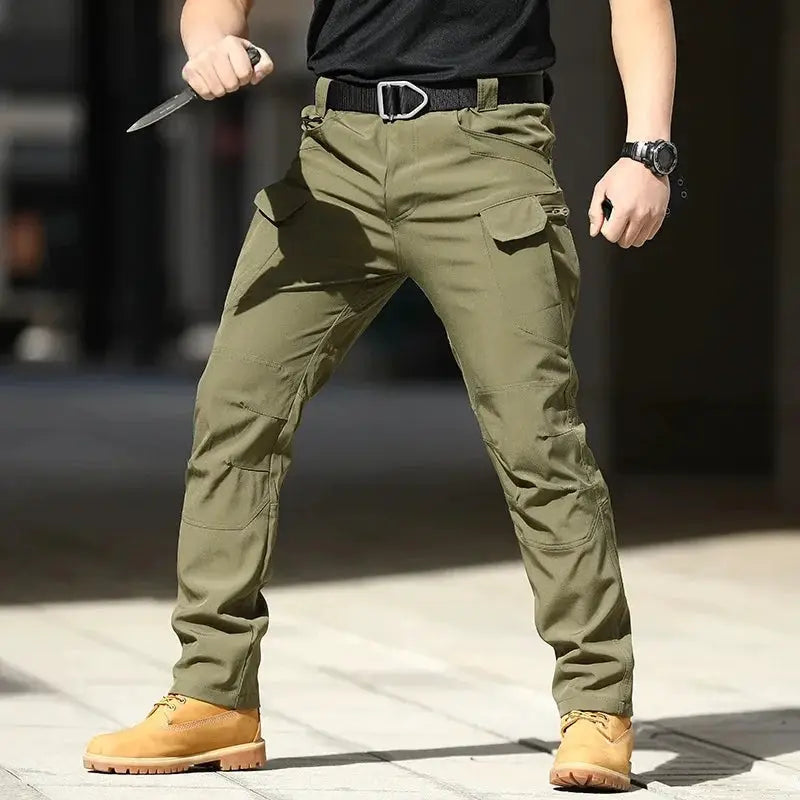 Men's Tactical Cargo Pants in olive green; softshell stretchy fabric with multiple pockets.