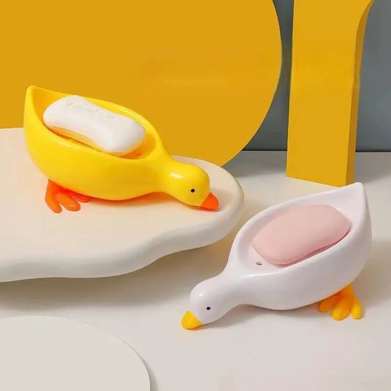Duck-shaped soap tray set (2 pieces) in yellow and white with self-draining design