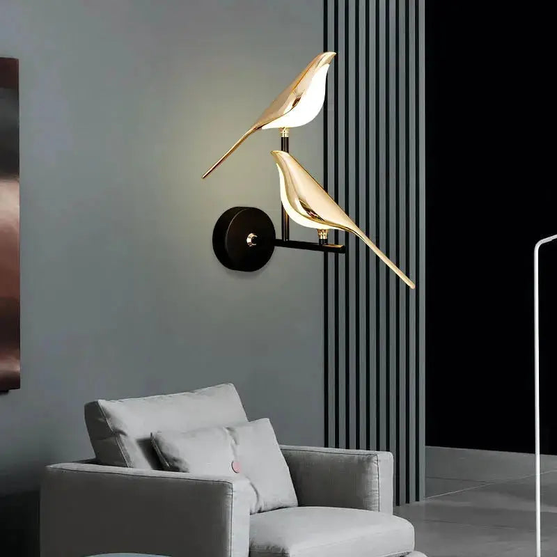 Modern LED wall lamp by Simples Market with two gold magpie bird sculptures on a black mount.