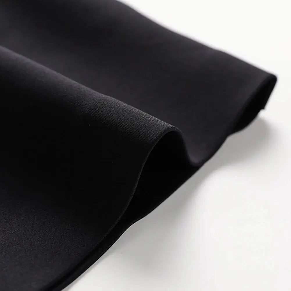 Strapless tube-top bra fabric in black, close-up of smooth matte material