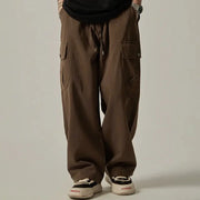 Men's cargo pants by Simples Market, brown wide-leg drawstring trousers with large cargo pockets.
