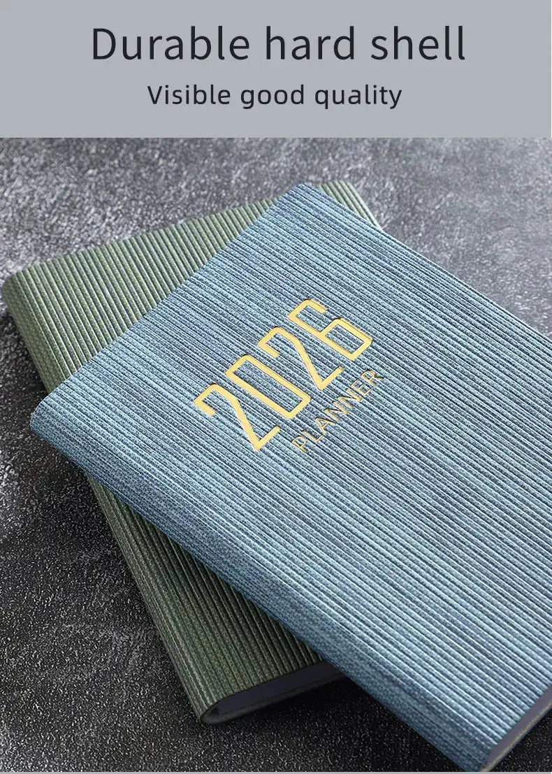 Two A7 pocket planners with textured striped blue and green covers, gold 2026 PLANNER on the blue one.