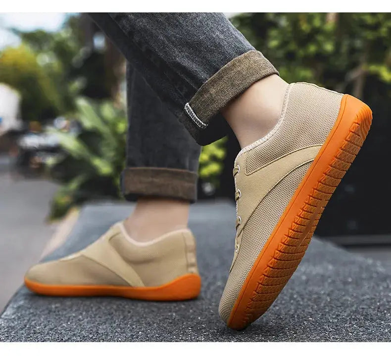 Men's minimalist trail running shoes with tan upper and orange outsole, wide width for gym workouts