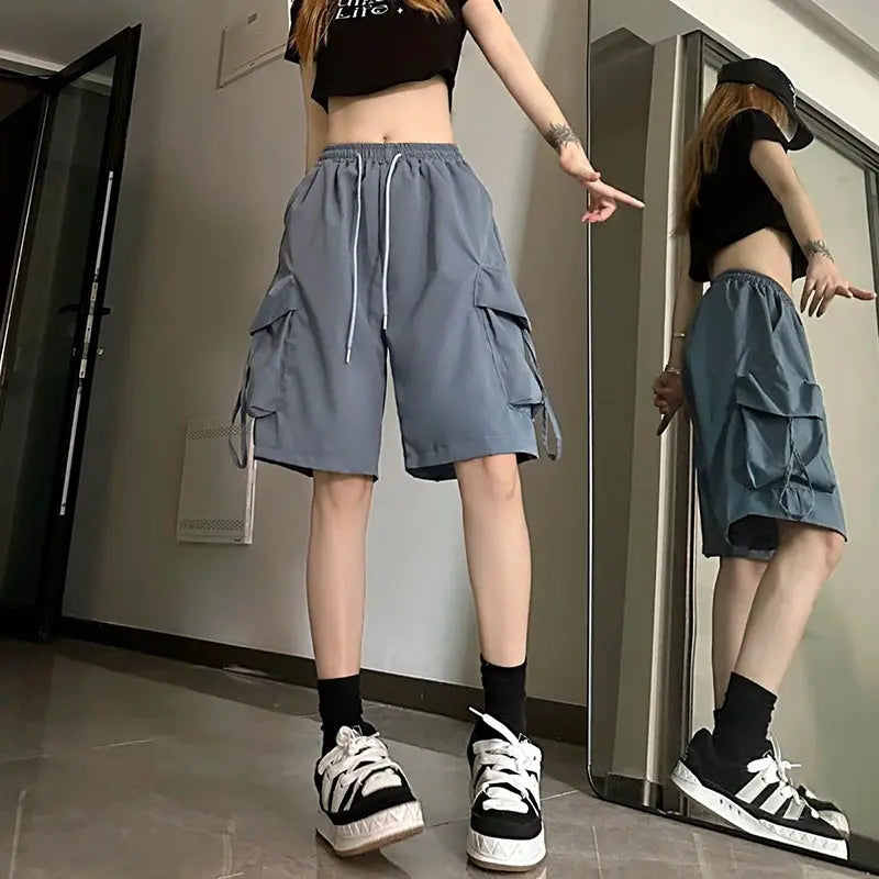ZOKI women's gray high-waist cargo shorts with large side pockets, drawstring waist, knee-length streetwear.