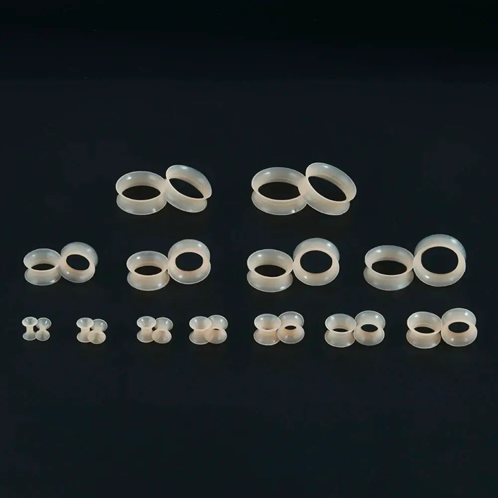 Ear tunnels set by Simples Market; flesh-toned translucent silicone, double-flare, several pairs.