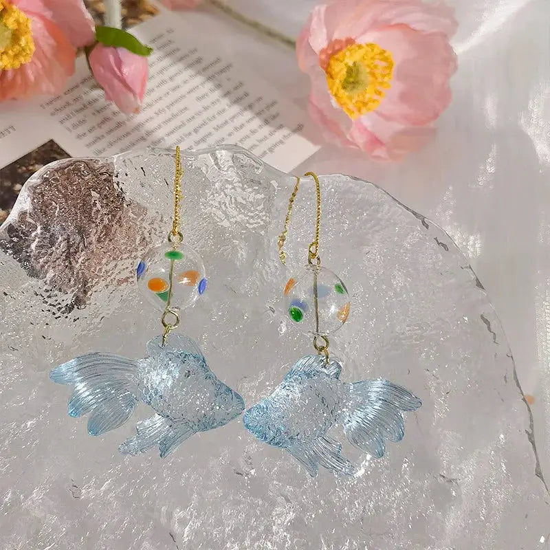 Goldfish pendant earrings, pair, transparent blue on gold chains with clear dotted beads in orange, green, and blue.