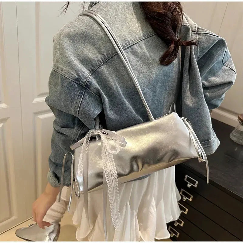 Shoulder bag by Simples Market, silver PU leather with bow lace accents, ballet-style crossbody.