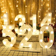 Number letter lamp set with warm white LED digits in white plastic for home or party decor