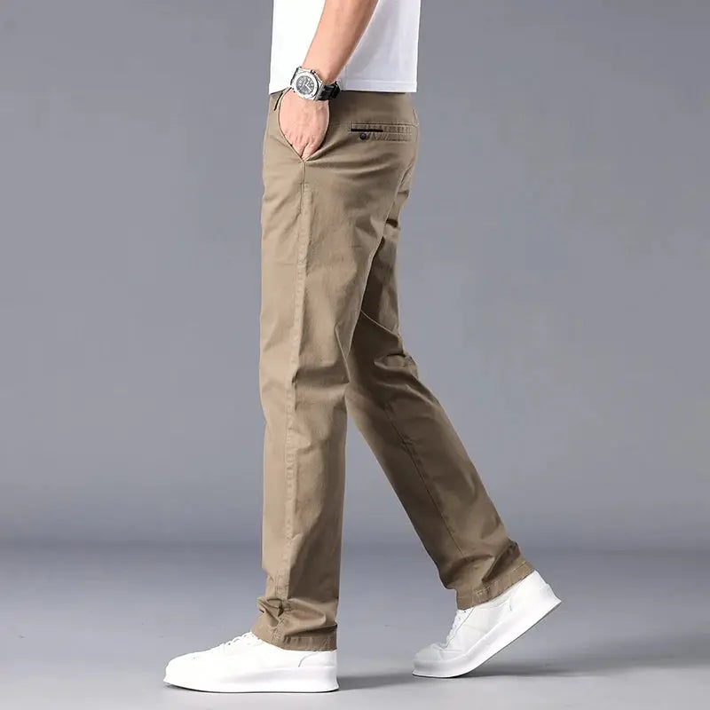 Men's straight-fit casual chinos in khaki with stretch fabric, worn with white sneakers