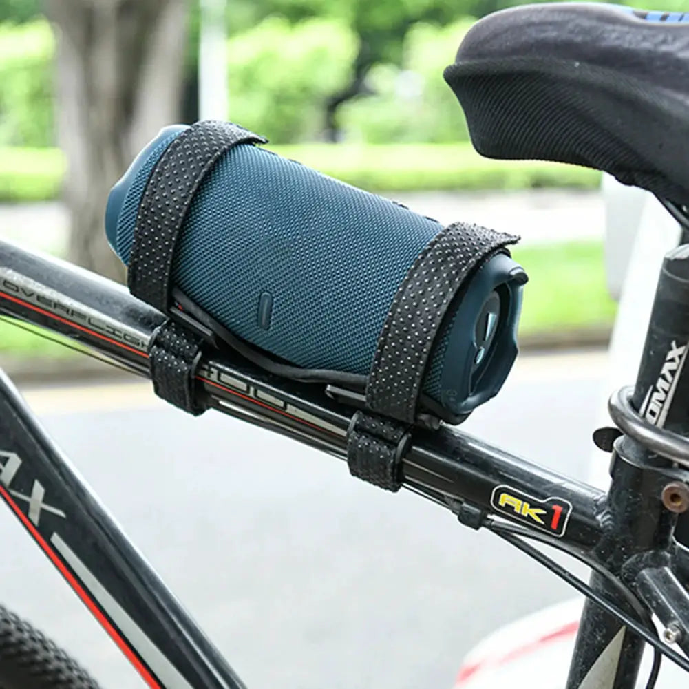 Speaker holder mount for bike; blue JBL Flip-style speaker secured with adjustable straps