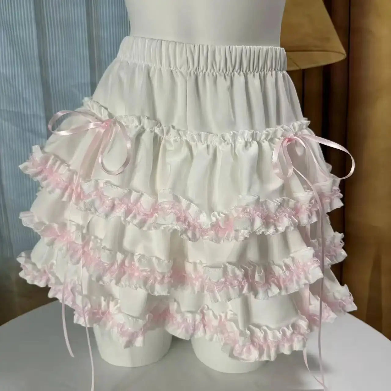 White Lolita cake skirt with pink lace trim, pink satin ribbons, elastic waist and tiered ruffles