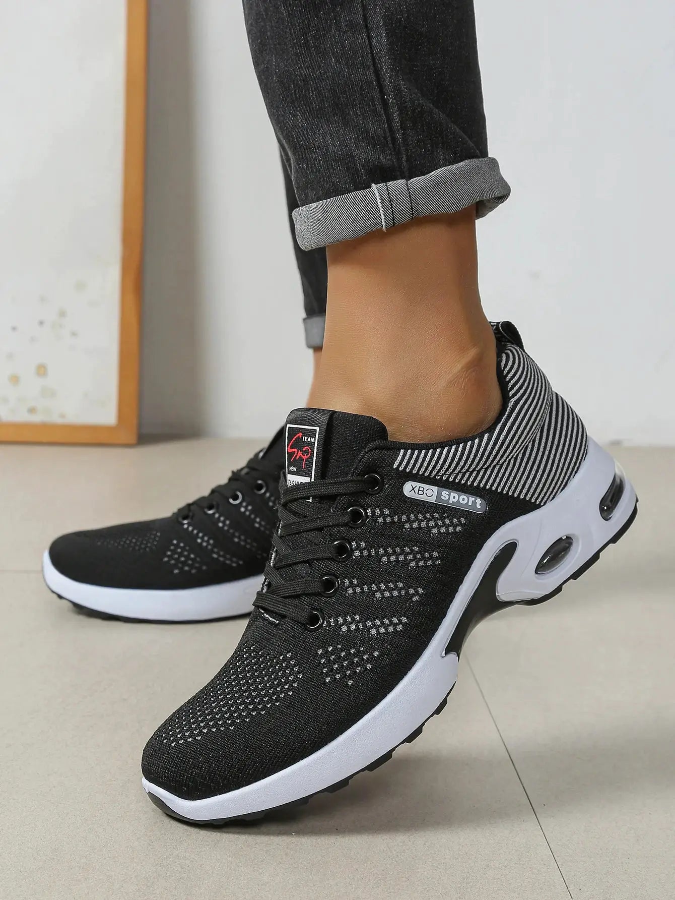 Men's black knit running shoes with white sole and XBC sport logo on tongue