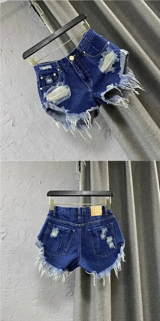 Women’s distressed denim shorts with frayed edges, irregular hem, zipper fly, blue vintage wash, back pockets