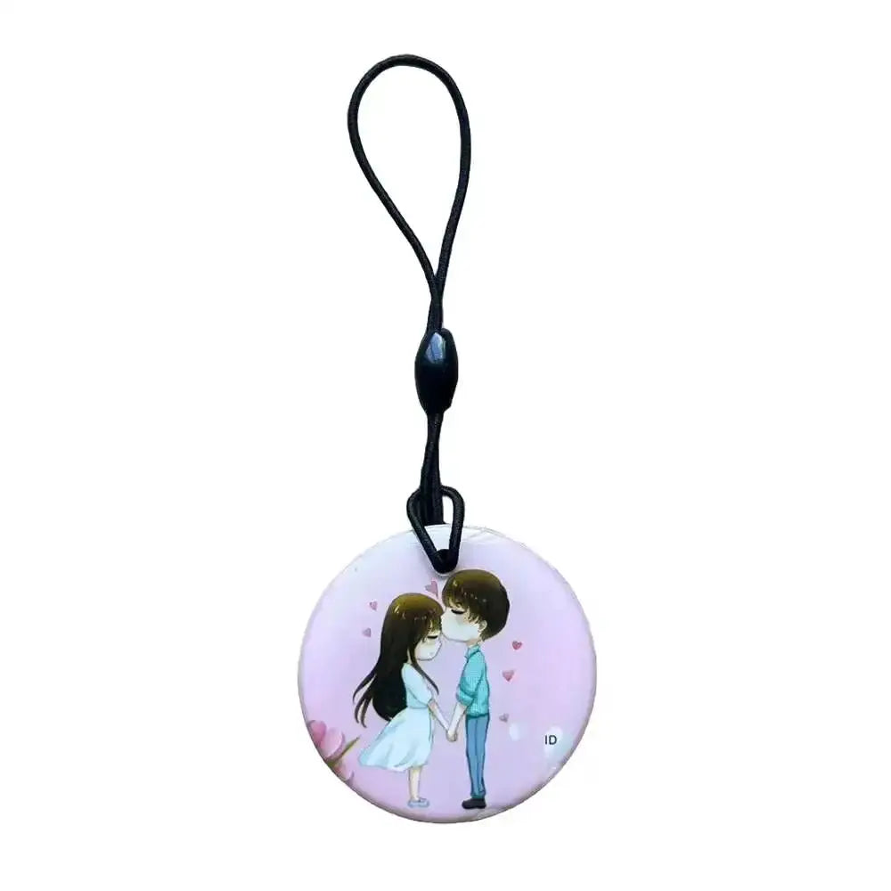 Simples Market round pink RFID key tag with black lanyard, featuring a couple illustration