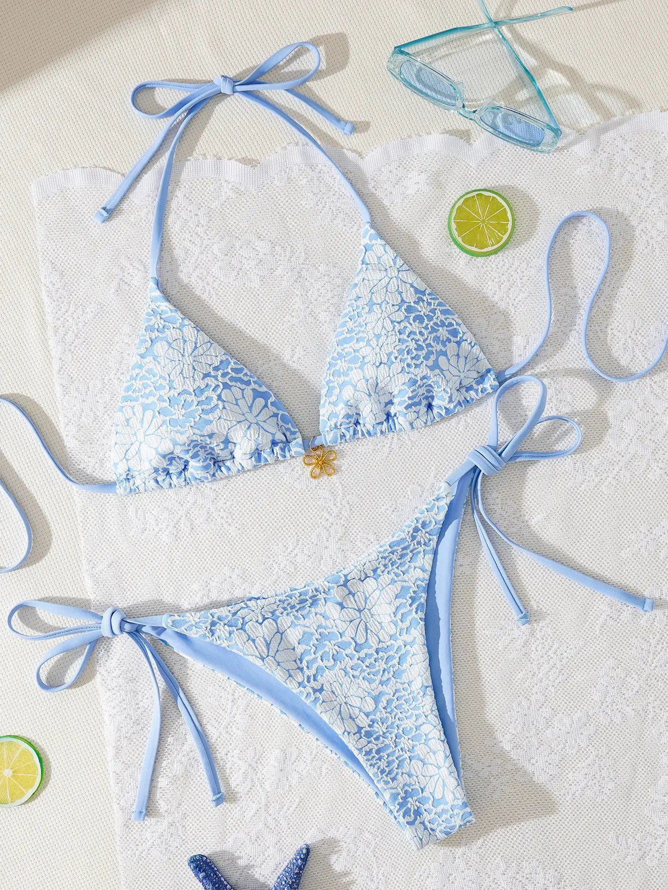 Triangle bikini set in light blue with white floral lace; string-tie top and Brazilian bottoms