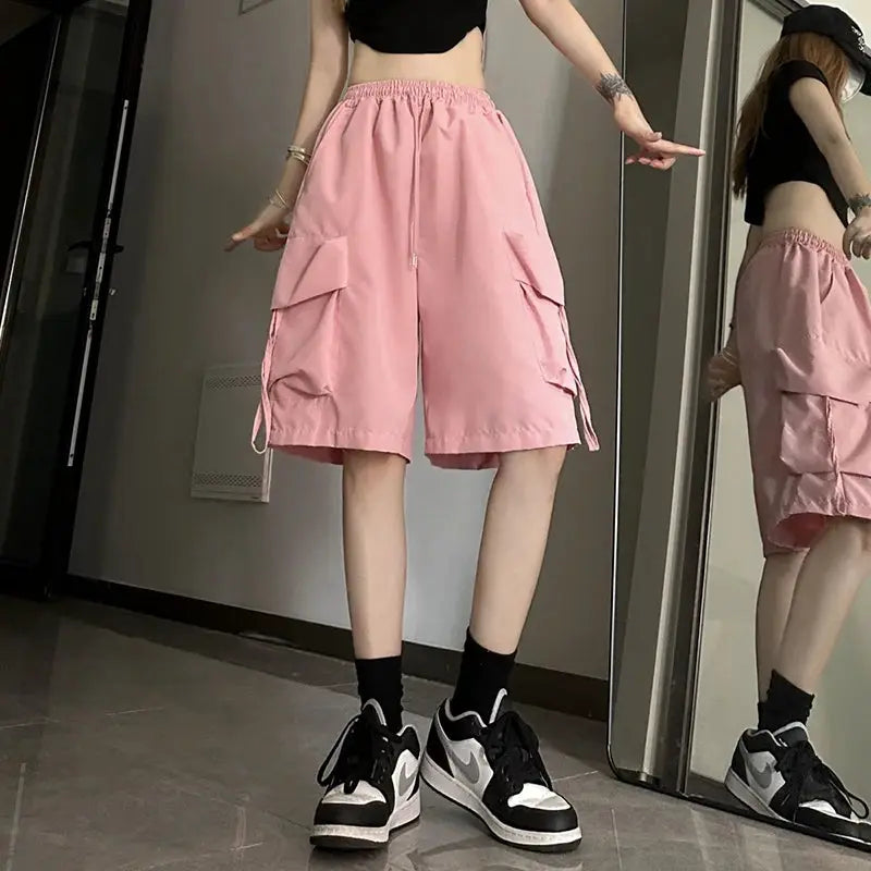 ZOKI women's pink high-waist cargo shorts with large side pockets and a loose wide-leg fit