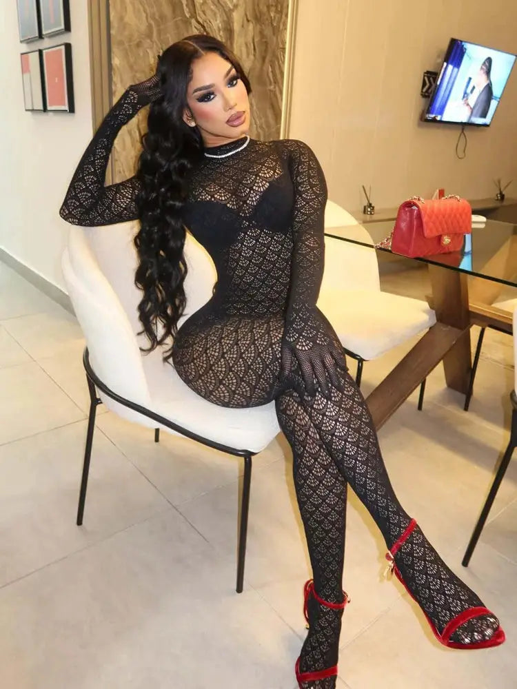 Women's black lace mesh jumpsuit romper with long sleeves, see-through bodycon fit.