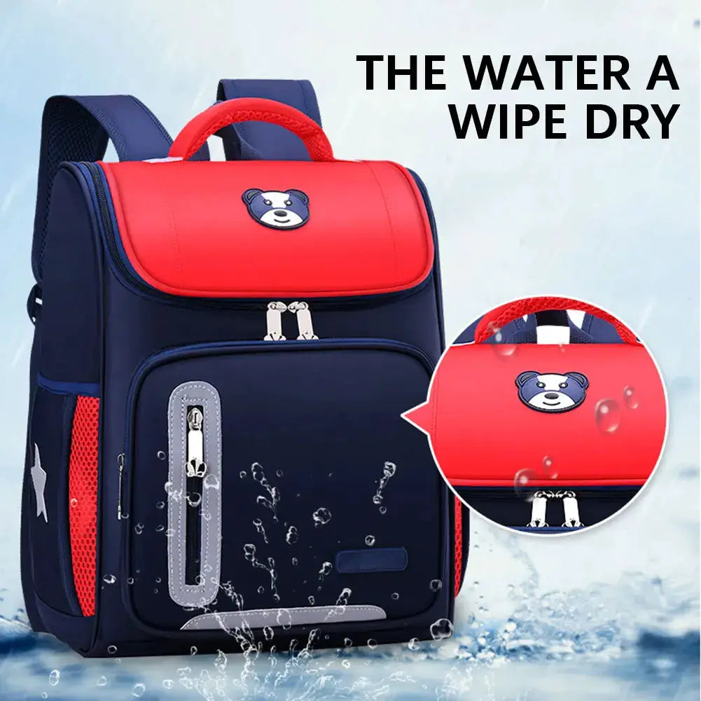 Kids school backpack by Simples Market; navy blue with red top, bear logo, reflective panel