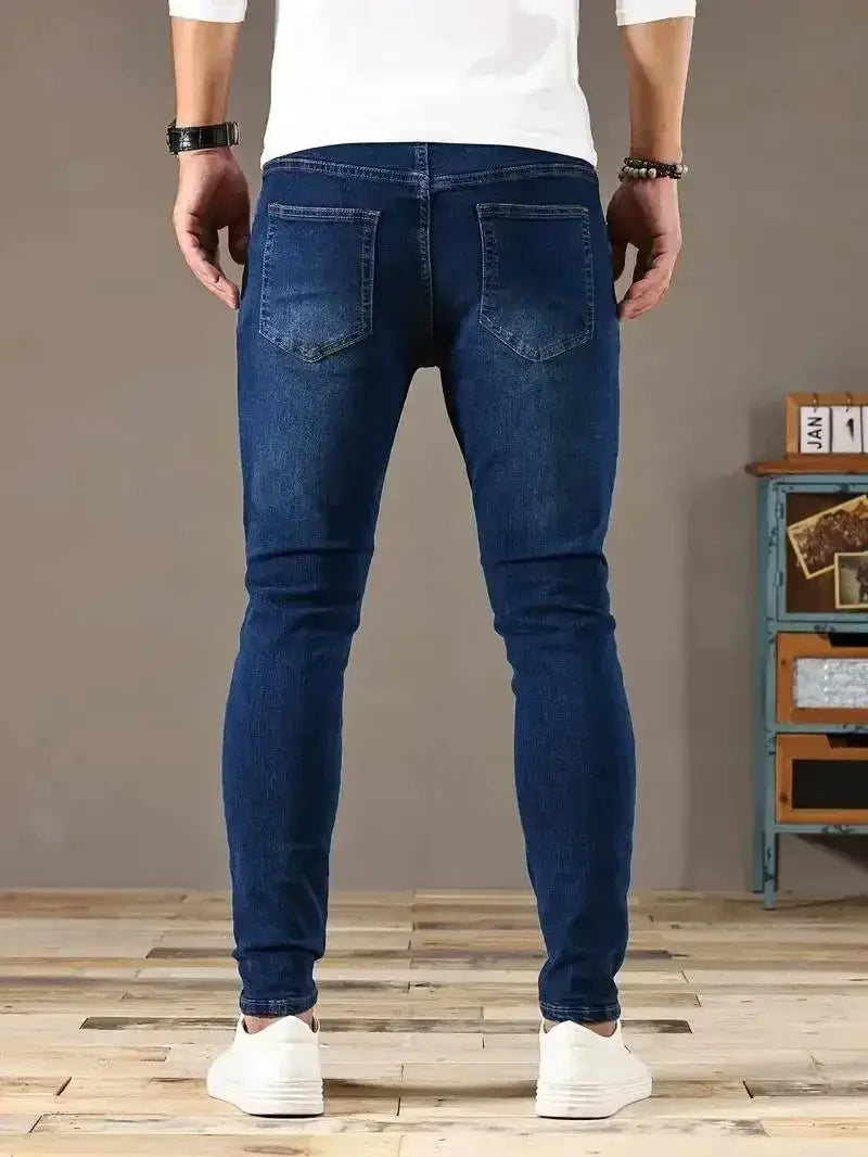 Men's stretch skinny denim jeans in blue, back view with rear pockets, slim fit