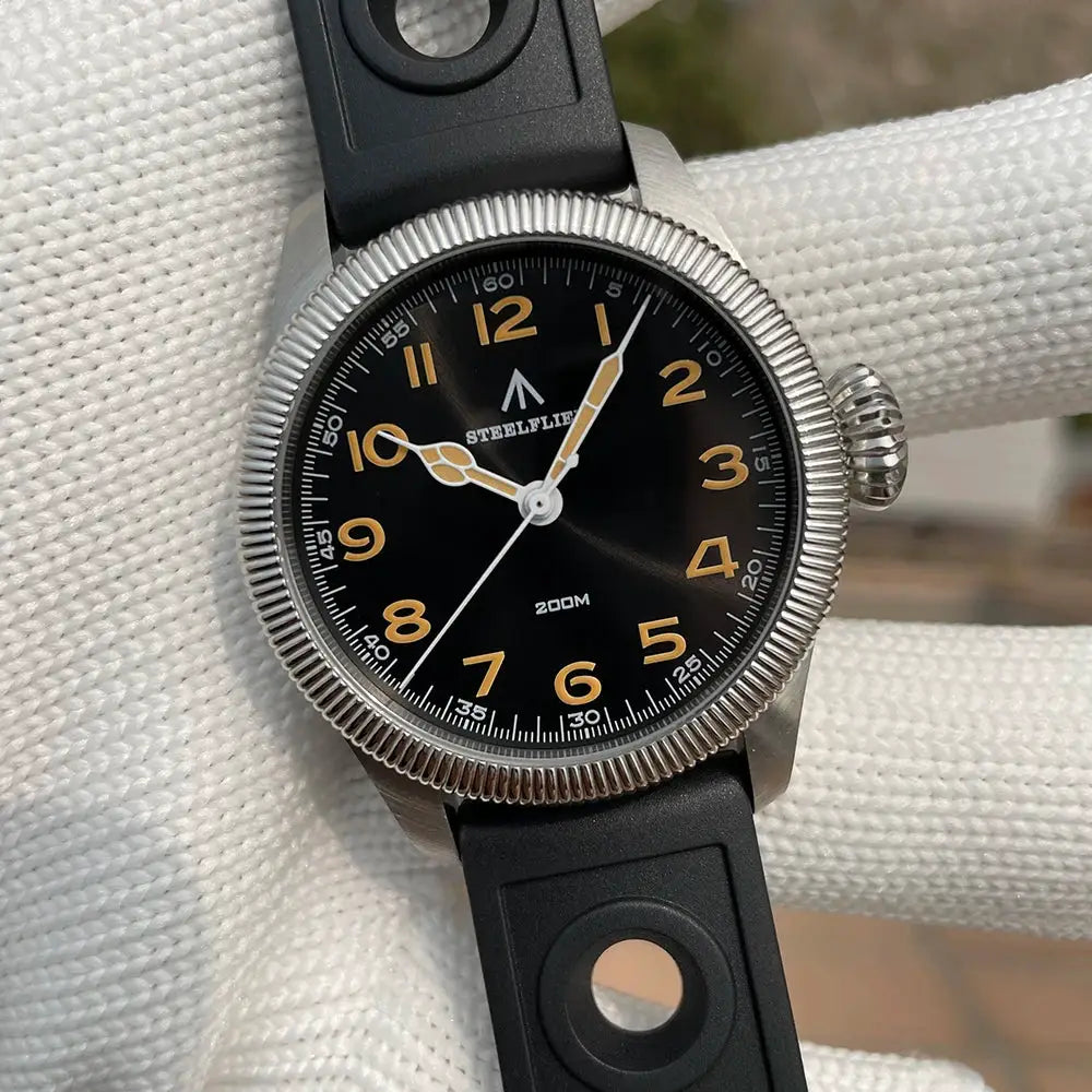 STEELFLIER SF741 wristwatch with black dial, gold numerals, stainless steel bezel, and black rubber strap