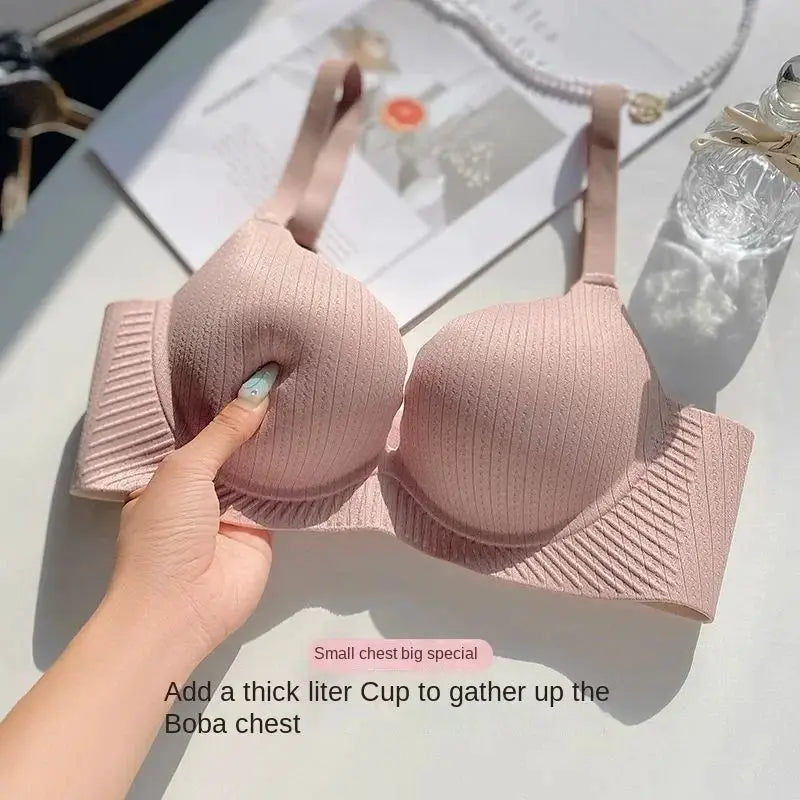 Push-up bra in pink ribbed fabric with 6 cm thick padding and a wide band for small-chest lift.