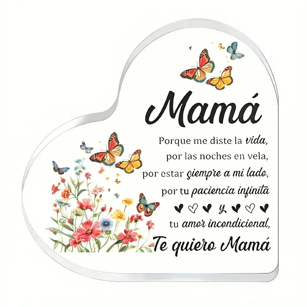 Heart-shaped transparent acrylic ornament with a floral bouquet, butterflies, and Te quiero Mamá text