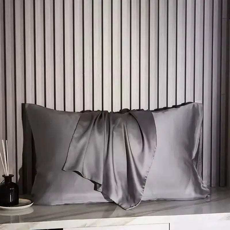 Nordic Silk pillowcase in silver gray satin on a bed, Simples Market bedding
