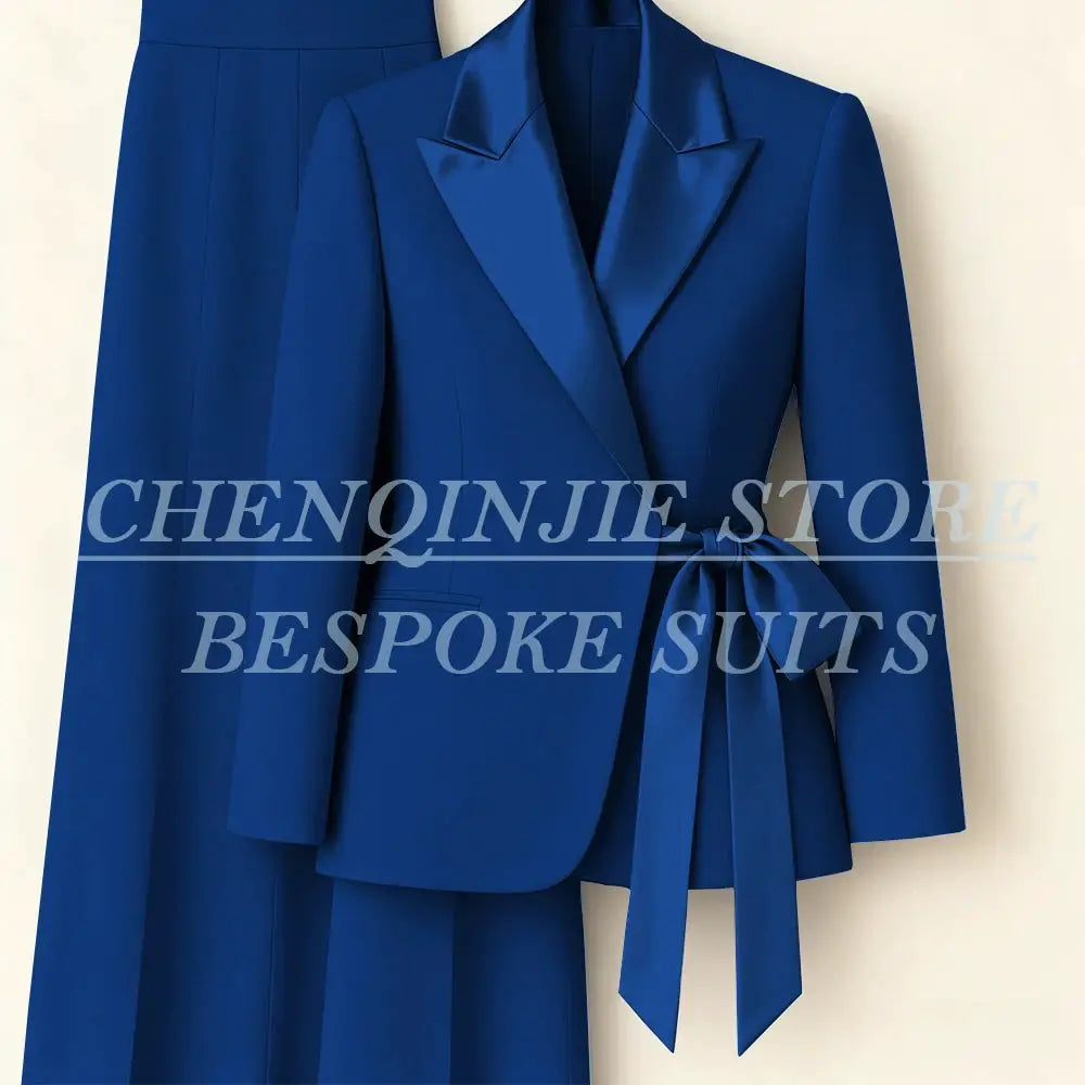 Women's blue 2-piece blazer suit with peak lapels and belted waist, matching pants
