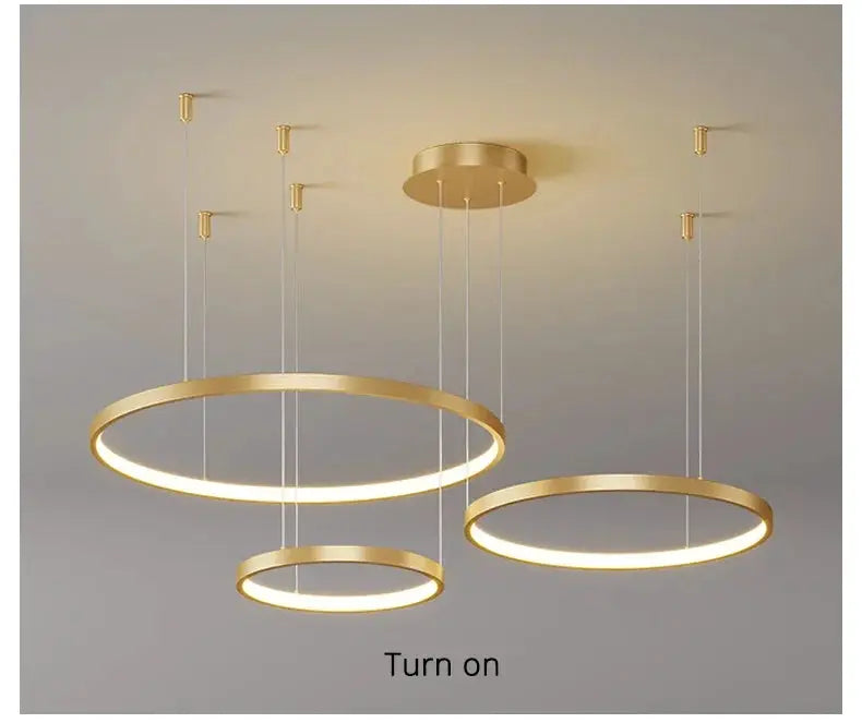 Three gold ring LED pendant lights for a modern living room chandelier