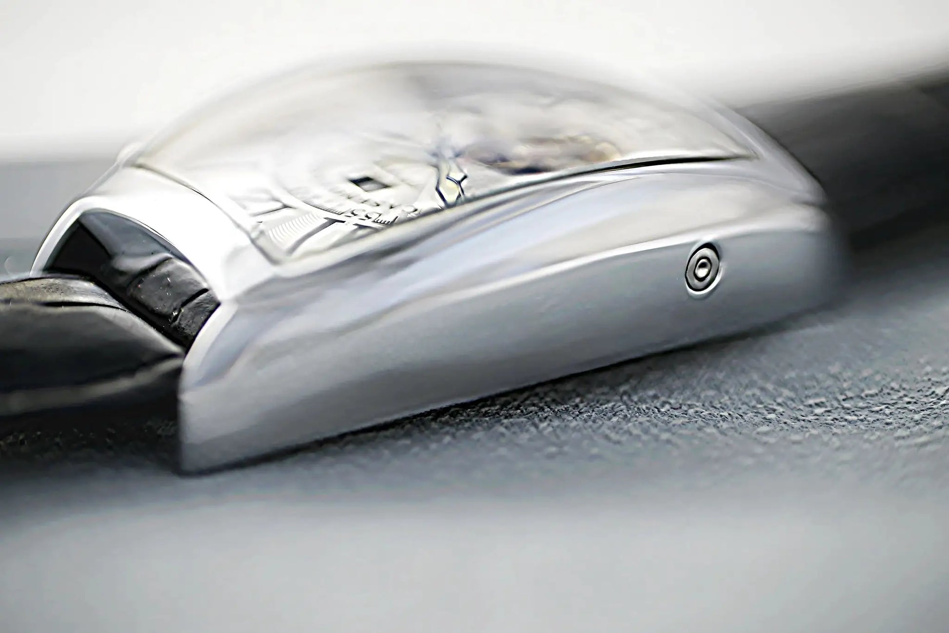 CASENO skeleton watch with silver tonneau case and black strap, close-up of exposed movement.