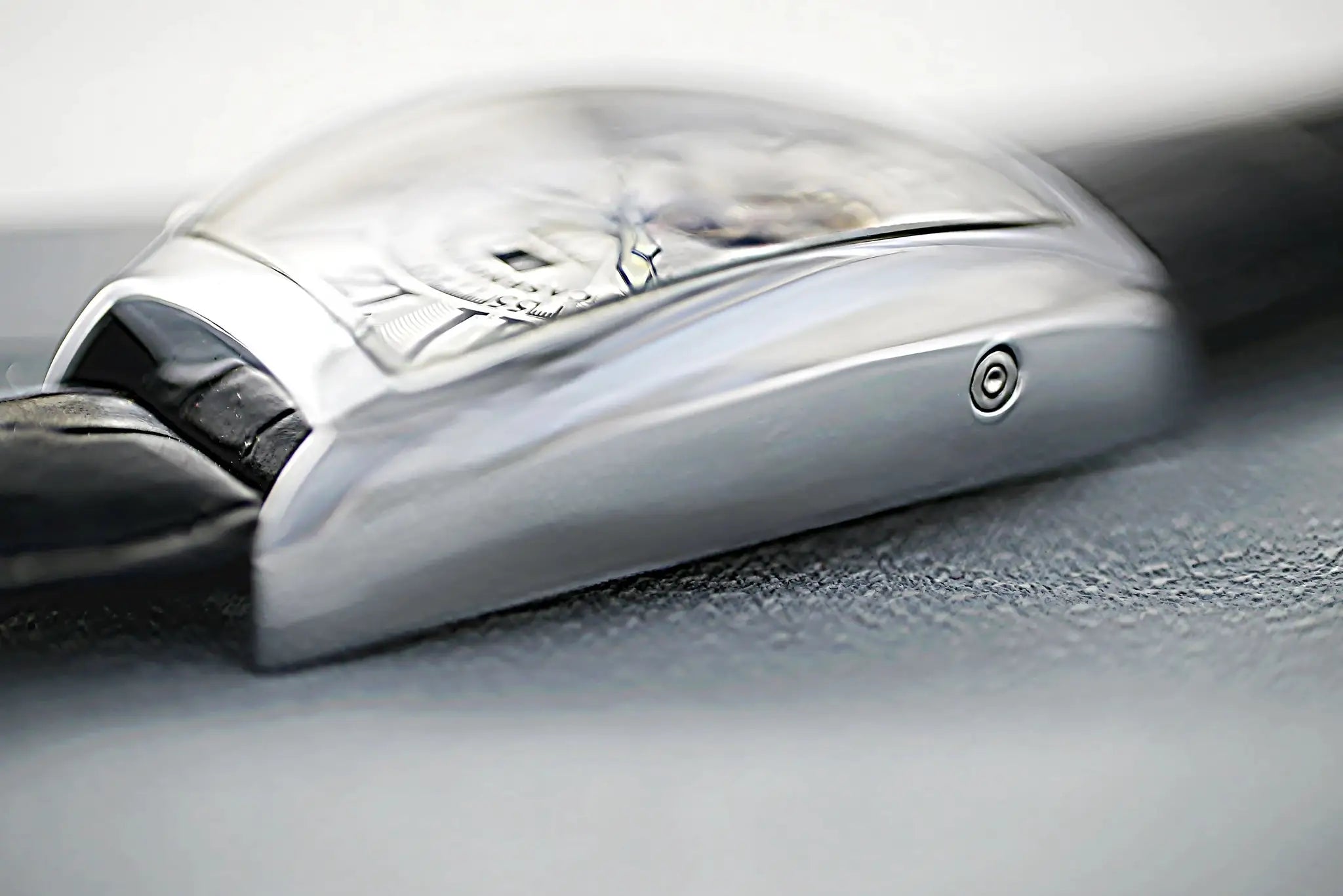 CASENO skeleton watch with silver tonneau case and black strap, close-up of exposed movement.